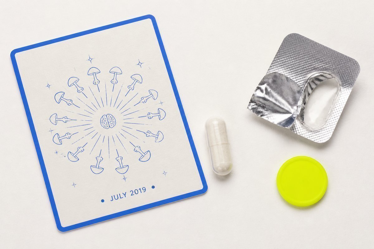 Bone review card, cobalt edge, lime chip: July 2019 leaf, capsule out of foil