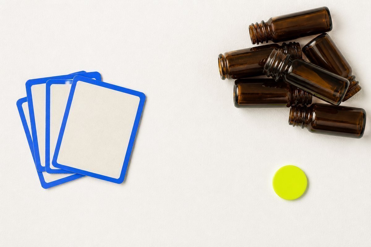 Bone review card, cobalt edge, lime chip: stacked drowsy bottles, gap